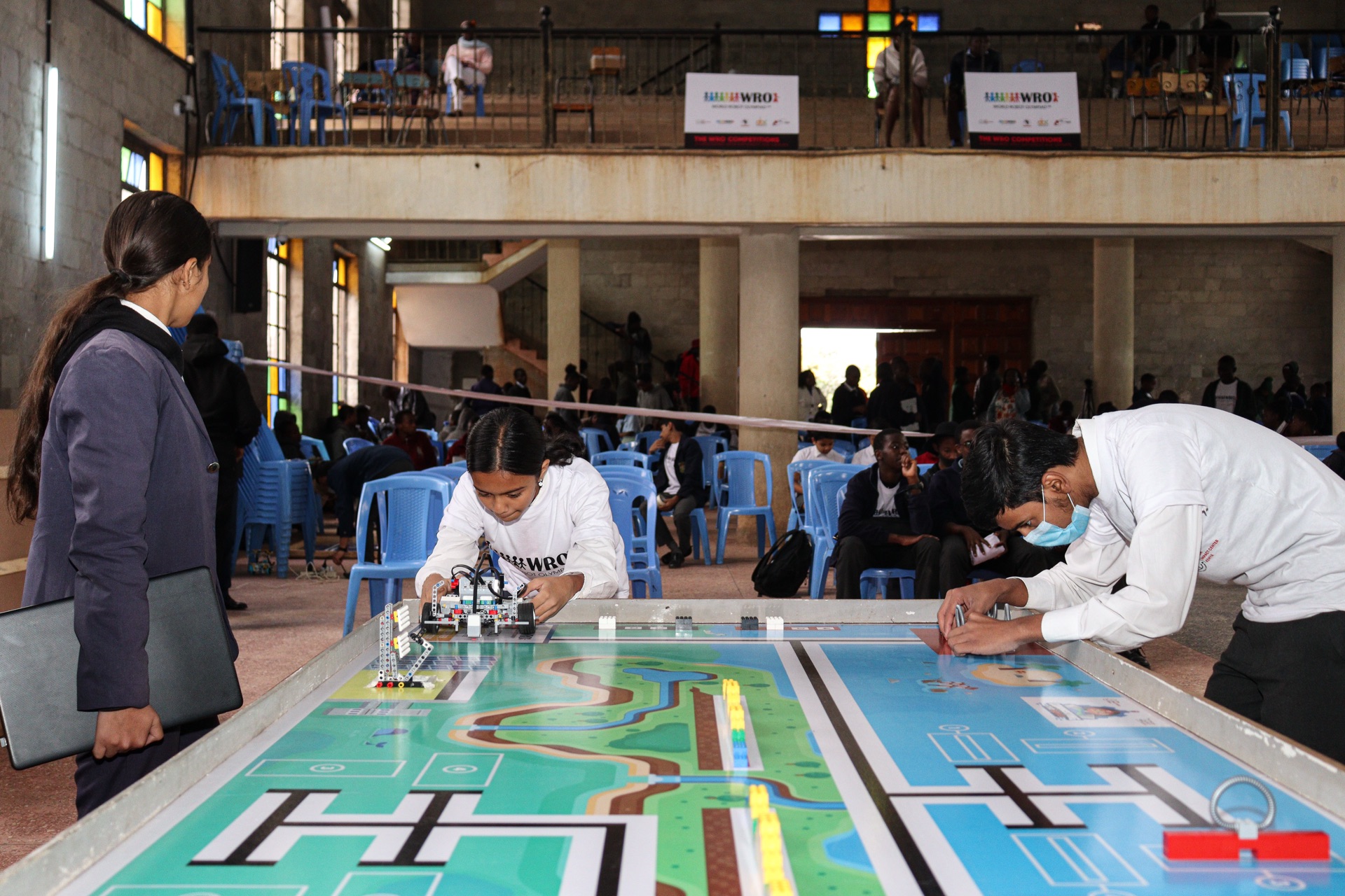 Student placing robot on mat